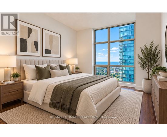 A bedroom with a large bed and a view of the city.