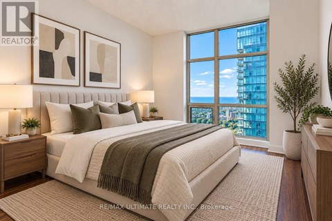 A bedroom with a large bed and a view of the city.