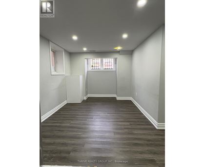 A room with wood flooring and white walls.