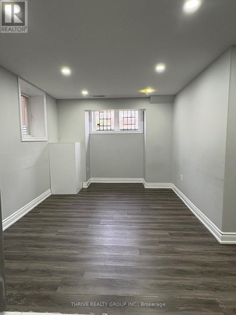 A room with wood flooring and white walls.