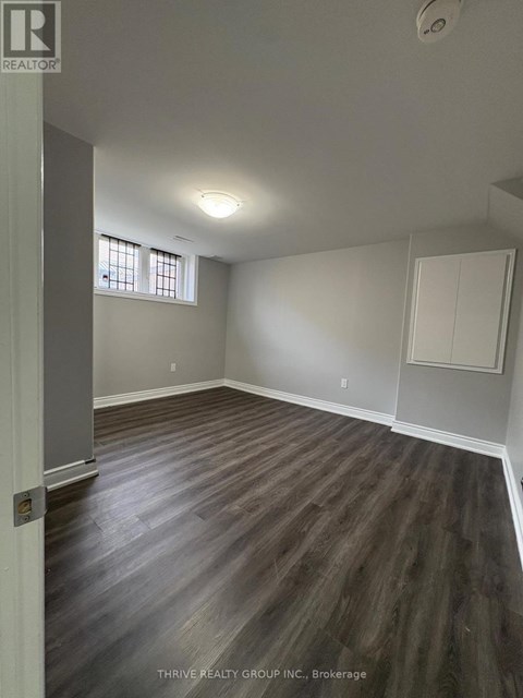 A room with wood flooring and a window.