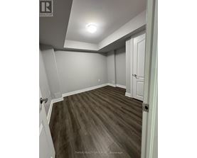 A room with a wooden floor and white walls.