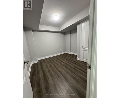 A room with a wooden floor and white walls.
