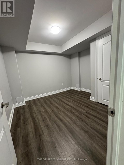 A room with a wooden floor and white walls.