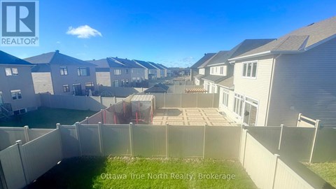 A row of houses with a fence in front of them.