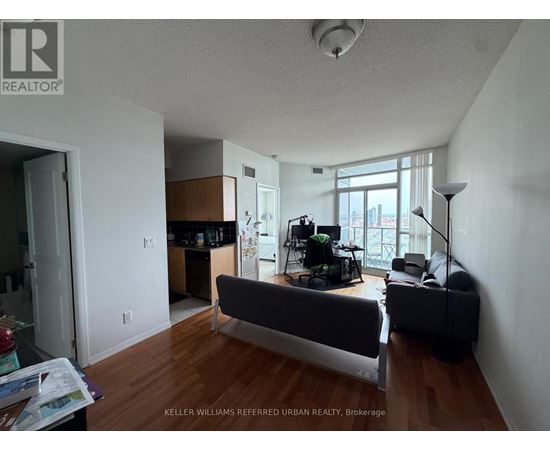 A living room with a couch and a television.