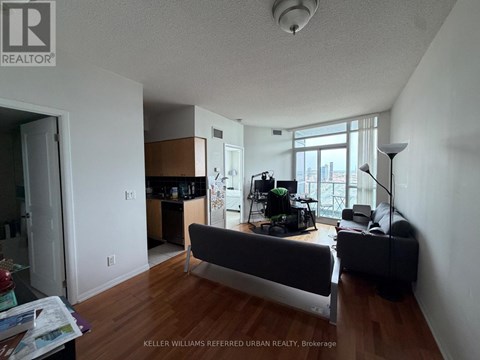 A living room with a couch and a television.