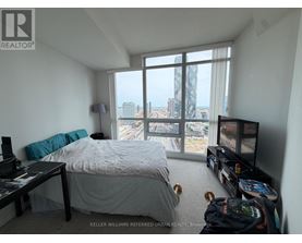 A bedroom with a large bed and a view of the city.