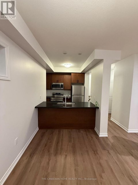 A real estate company's brokerage office with wood floors and white walls.
