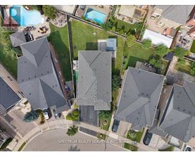 A bird's eye view of a neighborhood with houses and a pool.