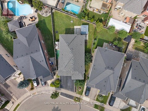 A bird's eye view of a neighborhood with houses and a pool.