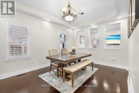 A dining room with a wooden table and chairs.