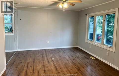 A room with wooden floors and a ceiling fan.