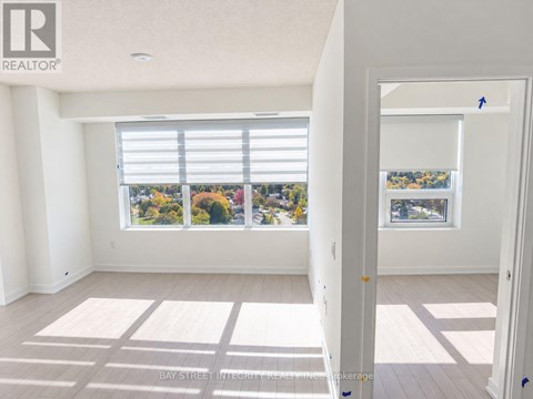 A room with a large window overlooking a street.