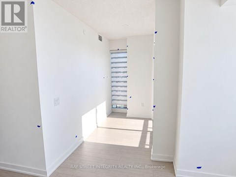 A white room with a window and a staircase.