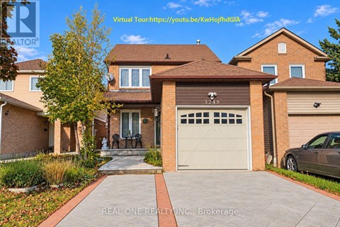 A house with a brown roof and a white garage door is for sale.
