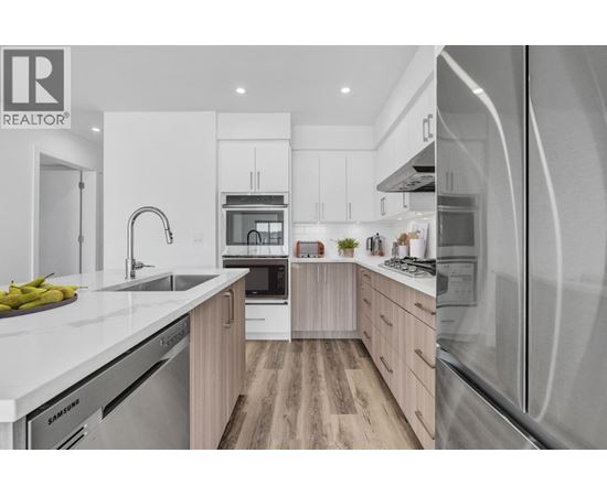 A modern kitchen with wooden cabinets and stainless steel appliances.