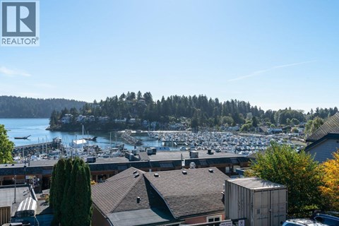 A view of a marina with boats and buildings.