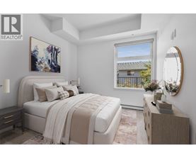 A bedroom with a large bed and a painting on the wall.