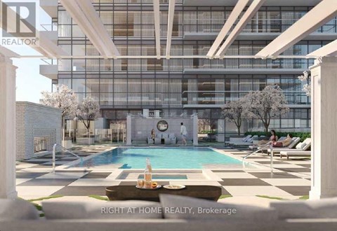 A modern building with a pool in front.