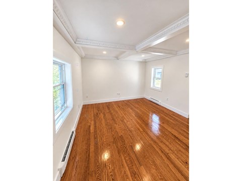 A room with wooden floors and white walls.