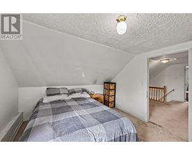 A bedroom with a bed and a nightstand.