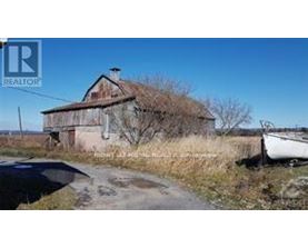 A realtor logo is on a picture of a run down building.