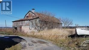 A realtor logo is on a picture of a run down building.