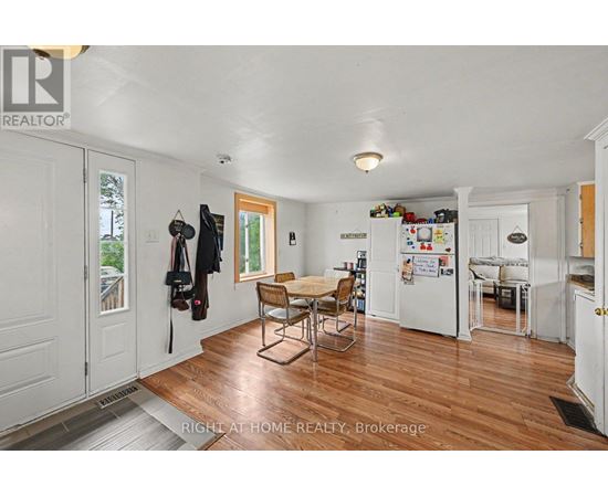 A kitchen with a table and chairs in the middle of the room.