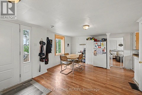 A kitchen with a table and chairs in the middle of the room.
