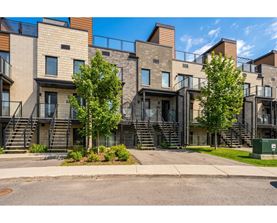 A modern apartment complex with a mix of brick and panel siding.