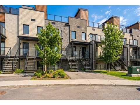 A modern apartment complex with a mix of brick and panel siding.