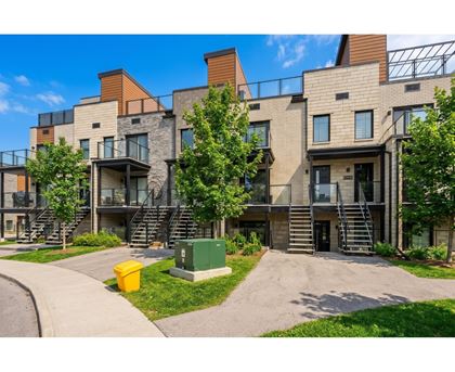 A modern apartment complex with a mix of stone and wood exteriors.
