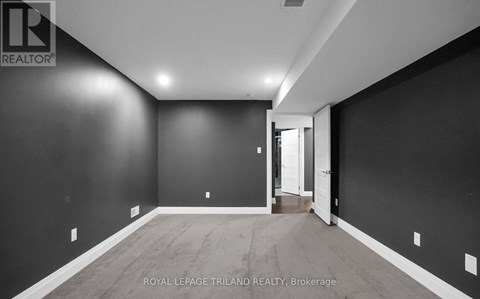 A spacious room with a doorway leading to another room.
