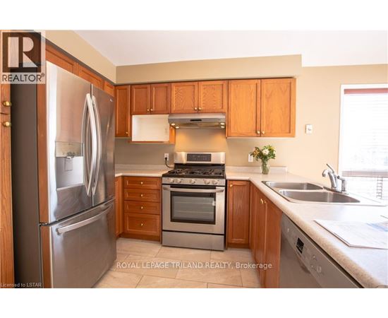 A kitchen with wooden cabinets and stainless steel appliances.