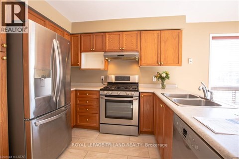 A kitchen with wooden cabinets and stainless steel appliances.
