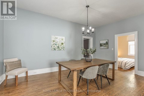 A dining room with a wooden table and chairs.