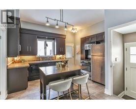 A modern kitchen with a dining table and chairs.