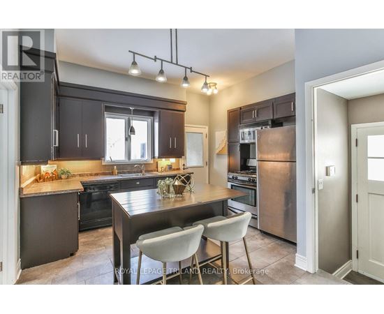 A modern kitchen with a dining table and chairs.