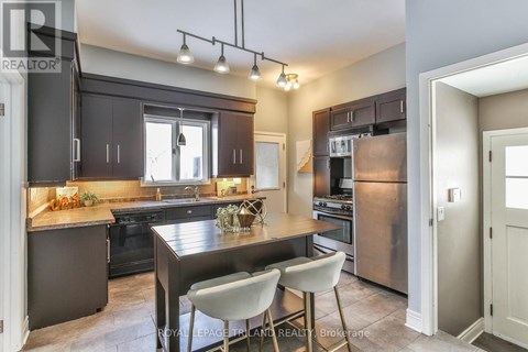 A modern kitchen with a dining table and chairs.