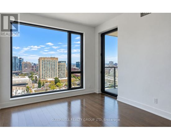 A room with a view of the city skyline through large windows.