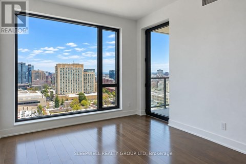 A room with a view of the city skyline through large windows.