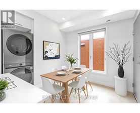 A modern dining room with a wooden table and white chairs.