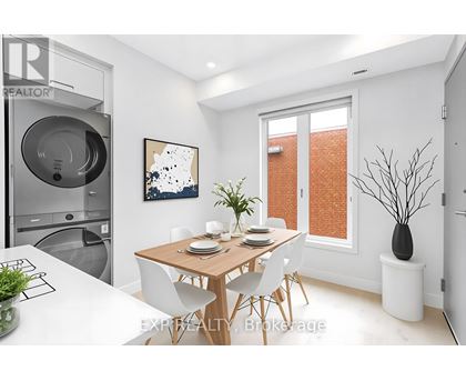A modern dining room with a wooden table and white chairs.