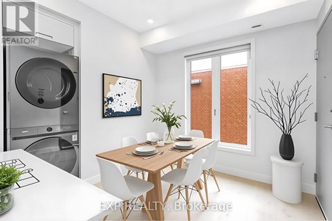 A modern dining room with a wooden table and white chairs.
