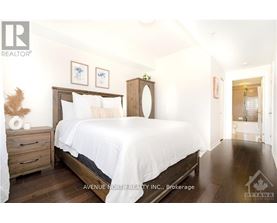 A bedroom with a large bed and a wooden headboard.