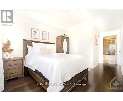 A bedroom with a large bed and a wooden headboard.