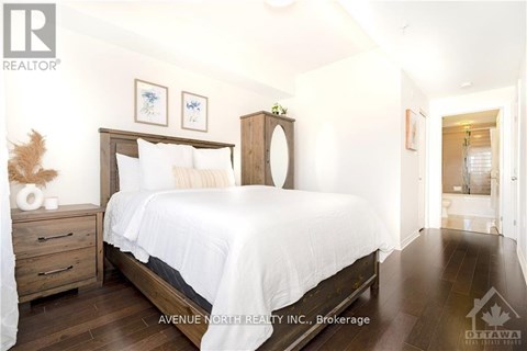 A bedroom with a large bed and a wooden headboard.