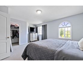 A bedroom with a large bed and a wardrobe.
