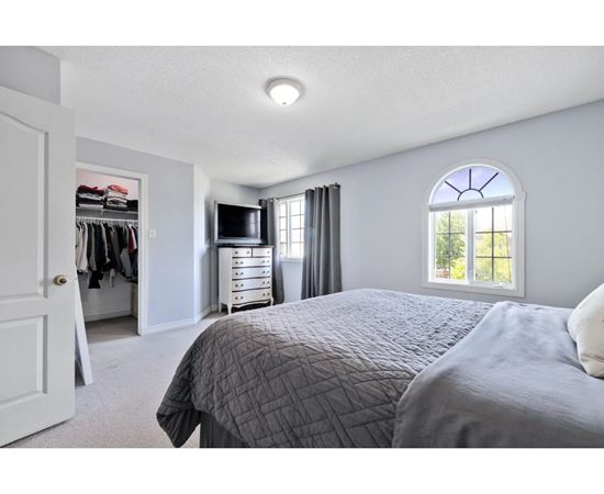 A bedroom with a large bed and a wardrobe.